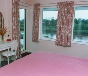 Master bedroom ensuite with door to sit out Balcony over River,Killorglin Riverbank Lodges