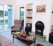  Living Room with wall of window and sliding double door to Terrace running full lenght of house overlooking River