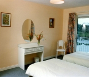 Twin bedroom with sit out Balcony over the River Killorglin Riverbank Lodges Kerry